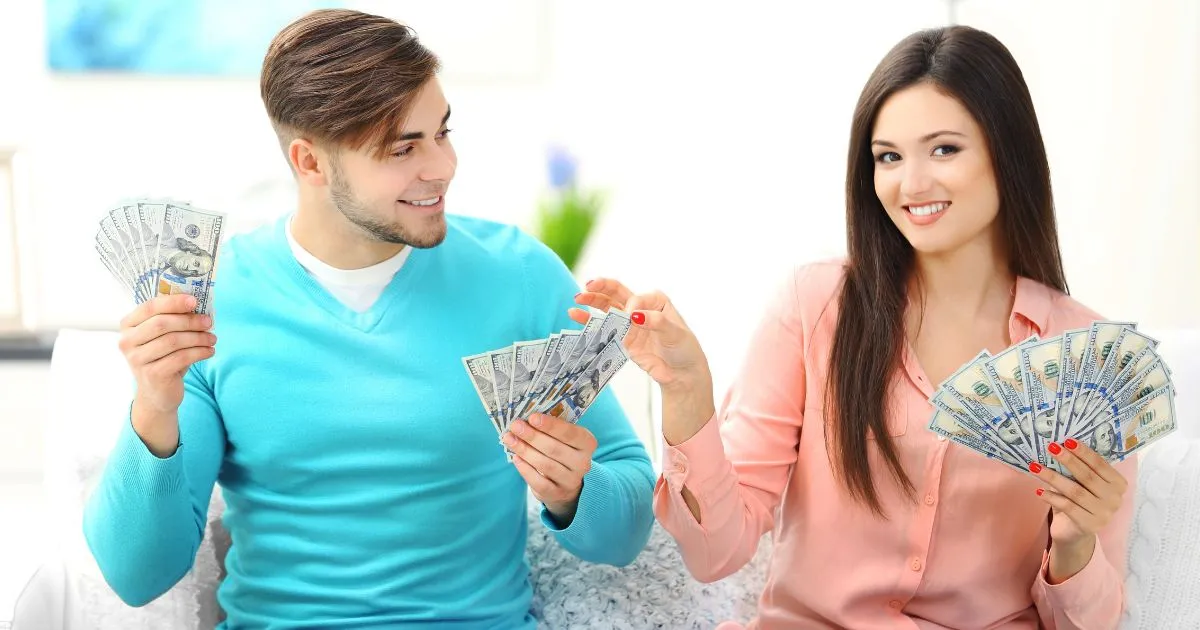 A couple counting money and relaxing while passive income streams flow, symbolizing financial freedom.