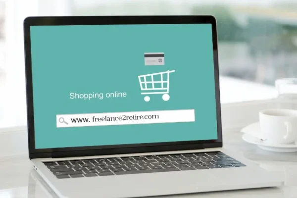 A laptop displays a teal screen with the text "Shopping online" and the website URL www.freelance2retire.com, alongside an online shopping cart icon.